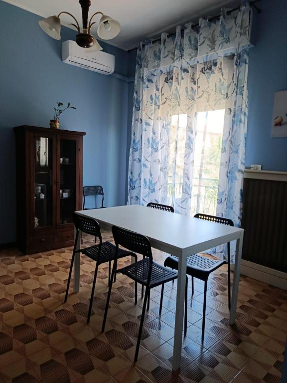 a table and chairs in a room with a window at La Ceramica in Appignano