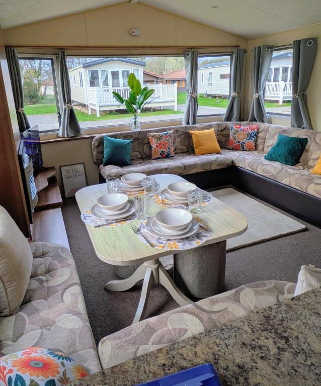a living room with a couch and a table at 26 The Meadows in Tattershall