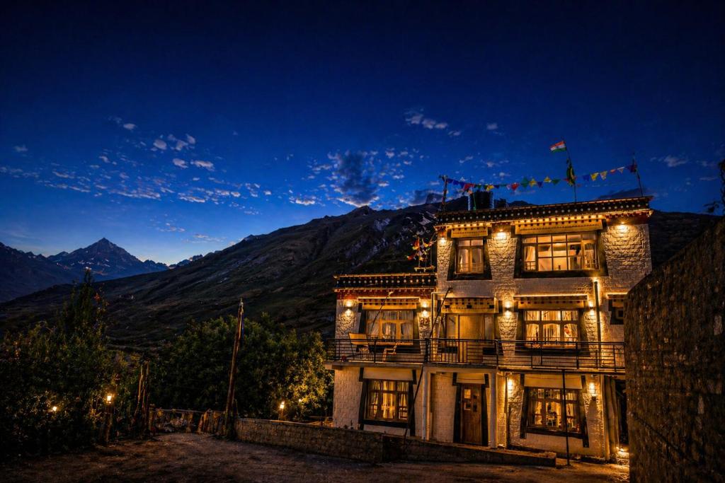 a large building with lights on it at night at Pema's Cottage by Outback Escapes in Kaza