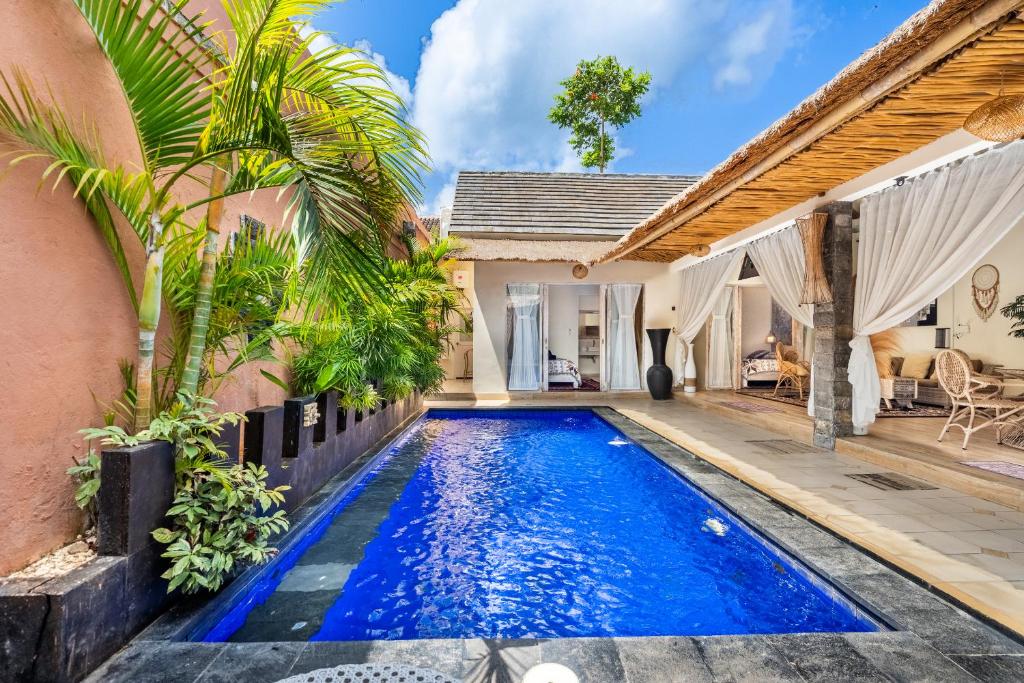 an image of a swimming pool in front of a house at Villa deluna in Jimbaran