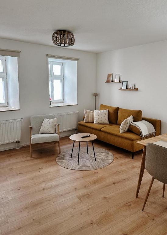 a living room with a couch and a table at FeelingHomeApartment in Dinkelsbühl