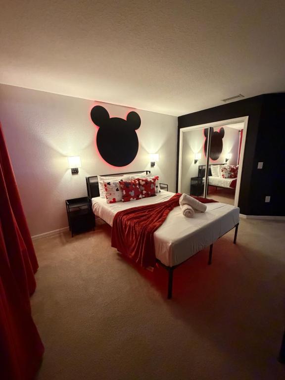 a bedroom with a bed with a mickey mouse headboard at Cozy Disney Stay in Kissimmee