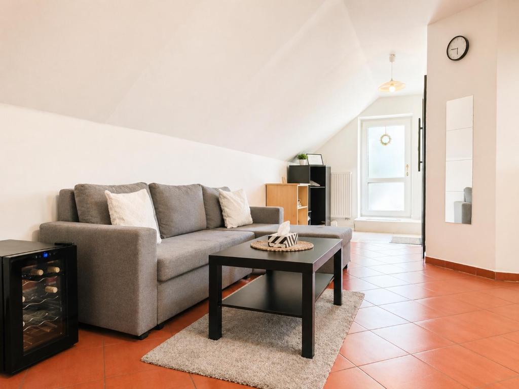 a living room with a couch and a coffee table at Atik V Borovičkách in Lipuvka