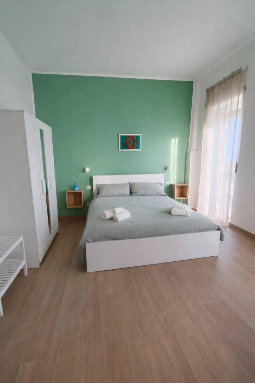 a bedroom with a large bed with blue walls at A Casa di Marco in Capua