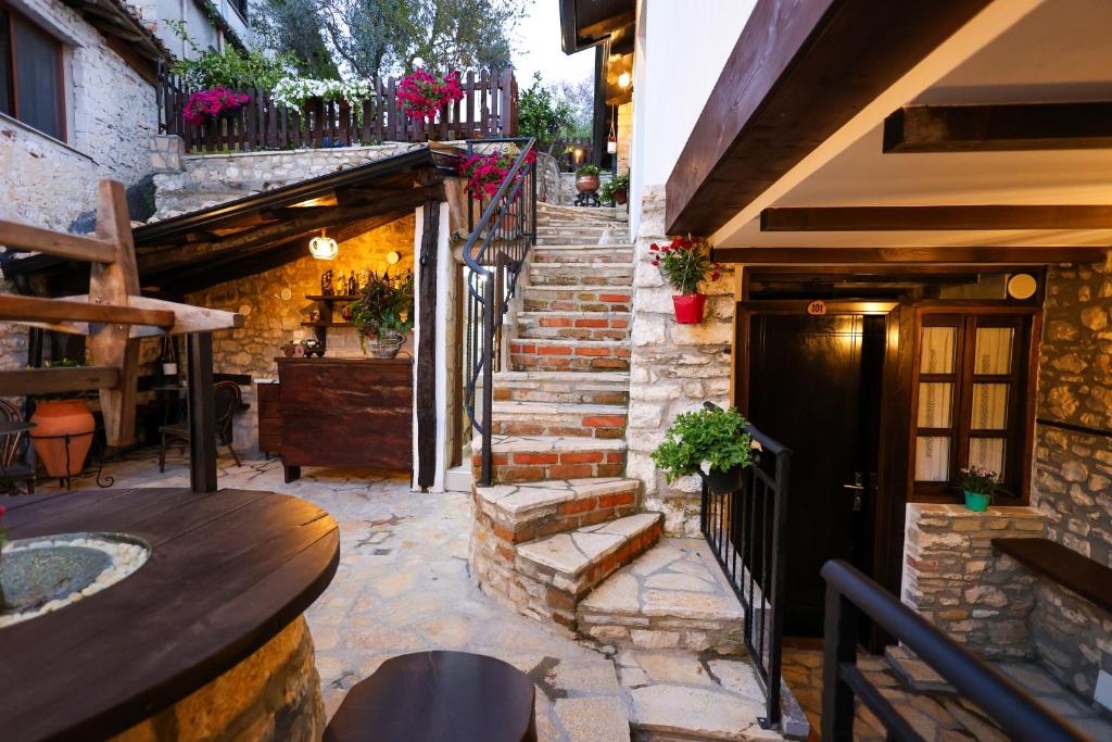 a stairway leading up to a building with flowers at Guest House Nina in Berat