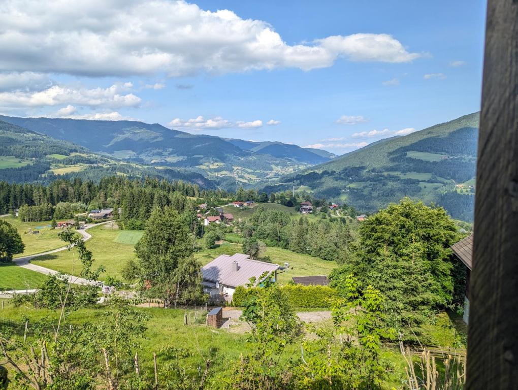 a view of a valley with mountains in the distance at artlodge TinyHouses in Treffen