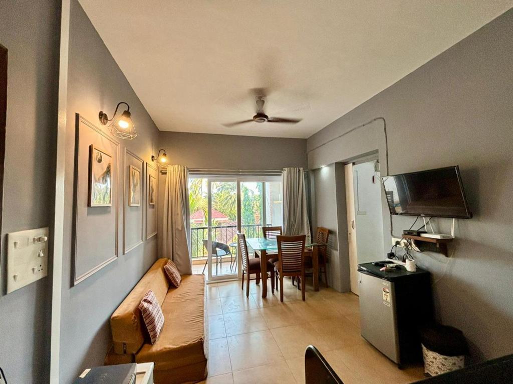 a living room with a couch and a table at Subtlestays in Arpora