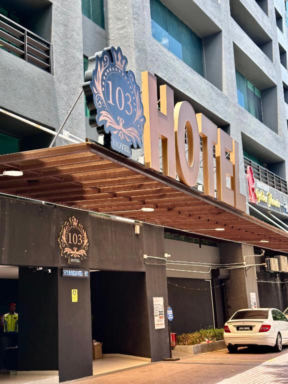 a hotel sign on the front of a building at 103 Hotel by manatidur in Kuala Lumpur