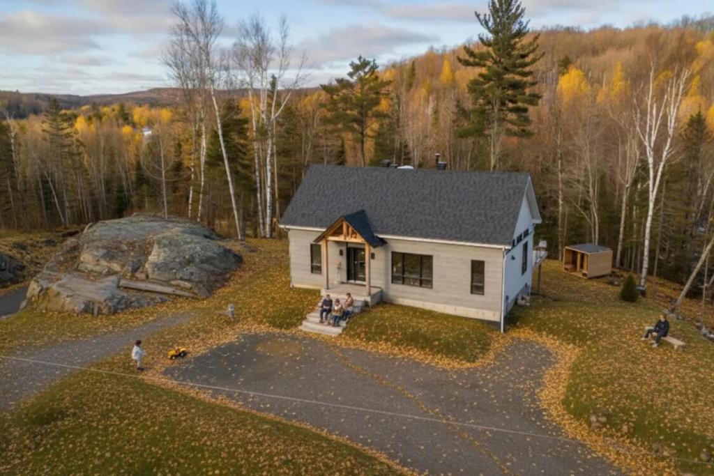 an overhead view of a small white house in the woods at Spa & Sauna Pool Table & Game Room - Le Perche in Brownsburg
