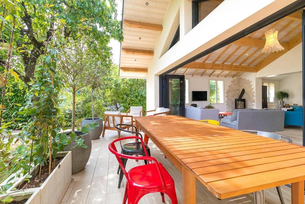 an outdoor patio with a wooden table and chairs at La Chateaubriand in Dijon
