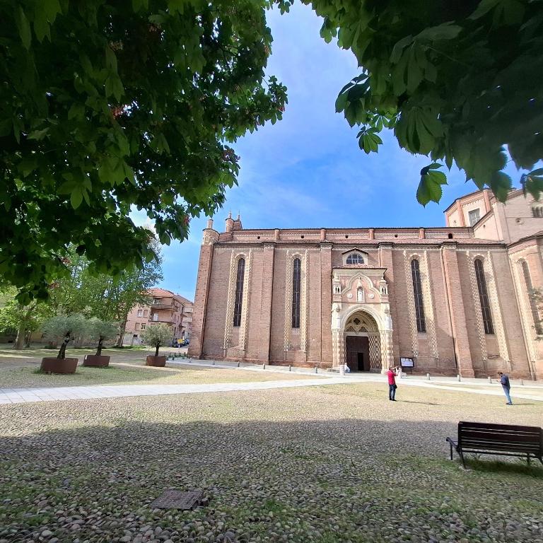 a large brick building with a large doorway at Quasi in Cattedrale, nel cuore storico di Asti in Asti