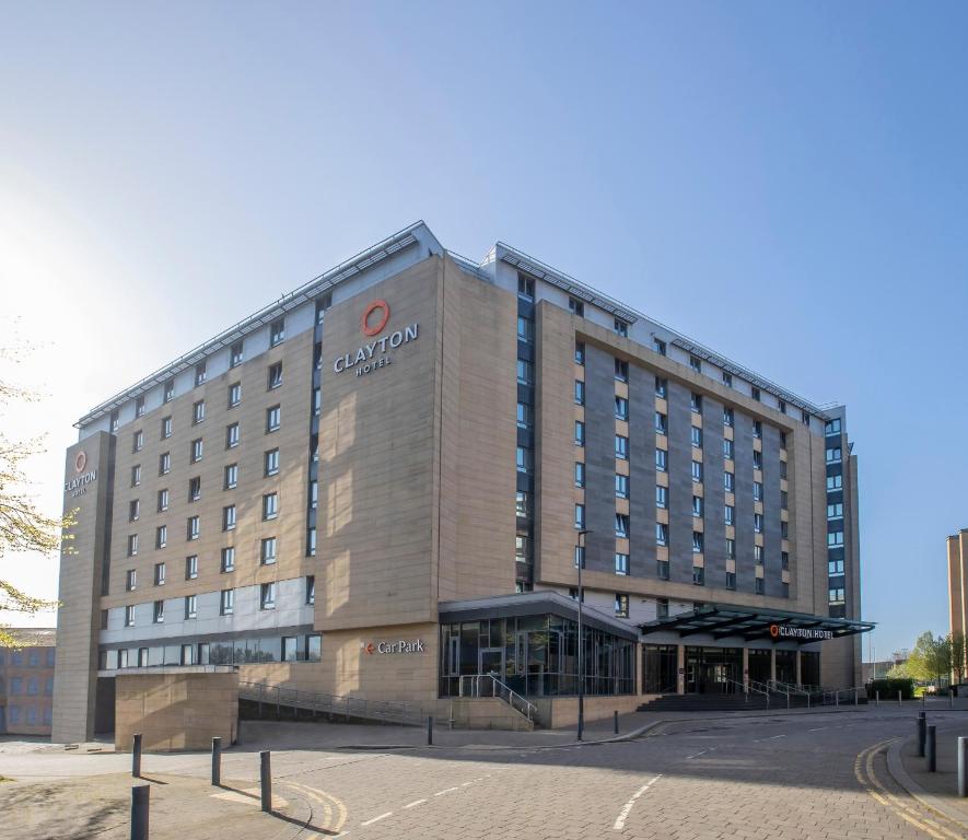 a large building with a sign on the side of it at Clayton Hotel, Leeds in Leeds