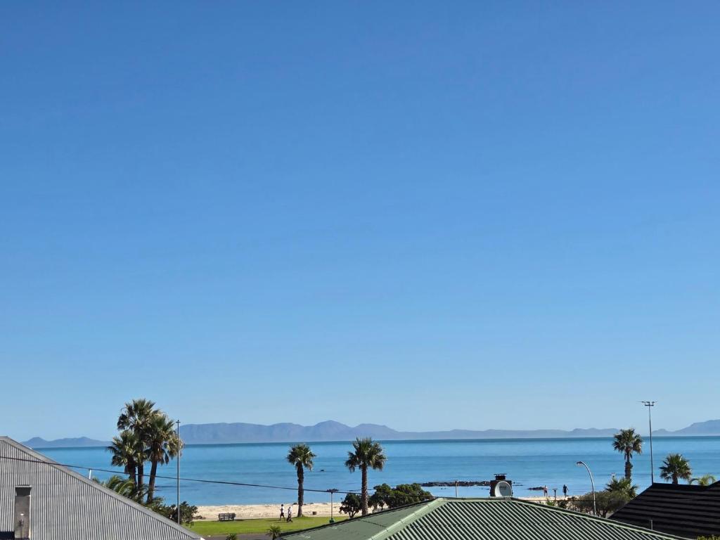 a view of the beach from the roof of a building at Charla on the Beach in Gordonʼs Bay