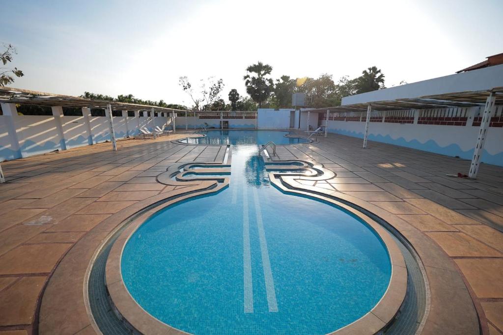a swimming pool on the roof of a building at La PAVI RESORT in Auroville