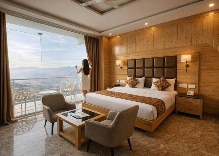 a hotel room with a bed and a balcony at Hotel Classic Crown - #Scenic mountain view #open terrace #guest preferred #best selling hotel in Mussoorie in Mussoorie