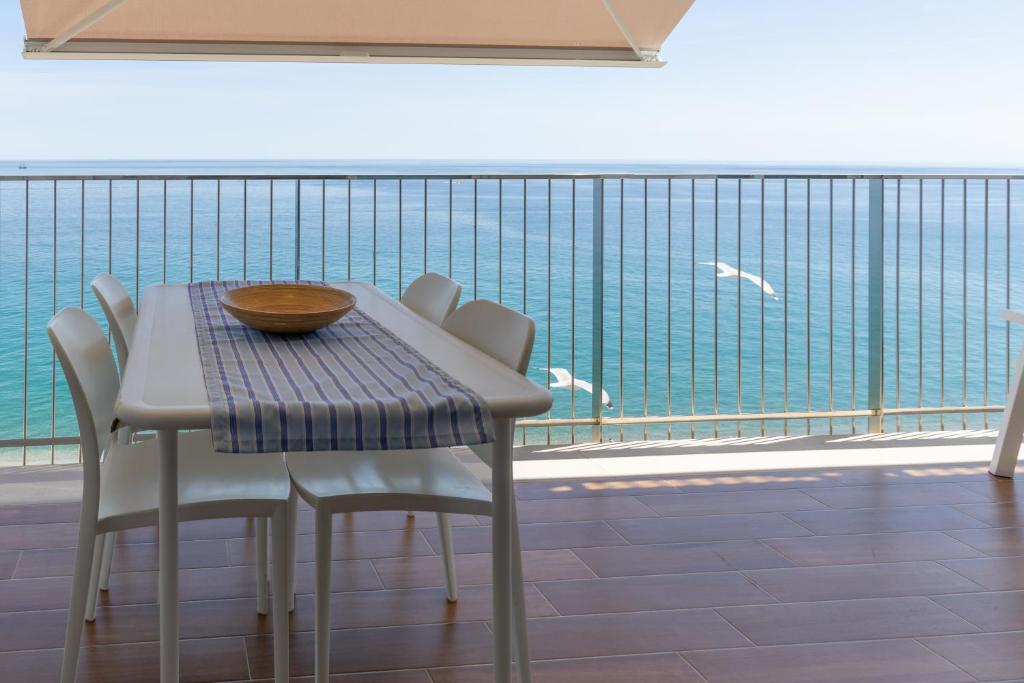 a table and chairs with a view of the ocean at Pis Embaixador - 1a línea de mar in Platja d'Aro