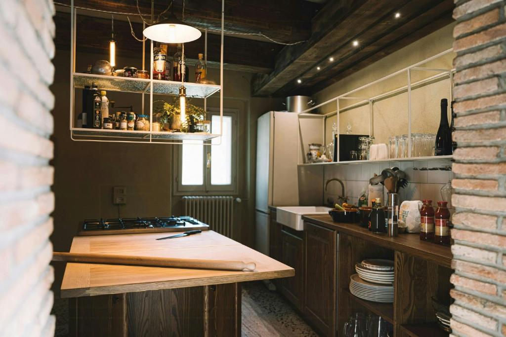 a kitchen with a counter top and a refrigerator at 18Th-Century Stone House By River In Romagna in Sarsina