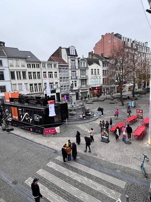 a group of people walking down the street in a city at Le Cecil in Liège