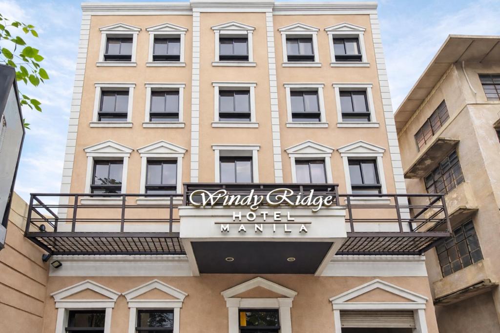 a building with a sign for a hotel named unity ridge at Windy Ridge Hotel Malate Manila in Manila