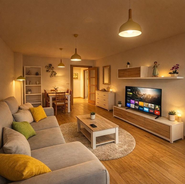 a living room with a couch and a tv at Villa Arán in Negreira