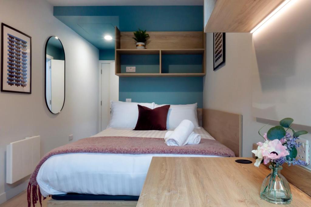a bedroom with a bed and a wooden table at Stoneybatter Place in Dublin