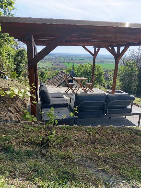 a gazebo with two couches and a table at Piqueno Vendégház in Celldömölk
