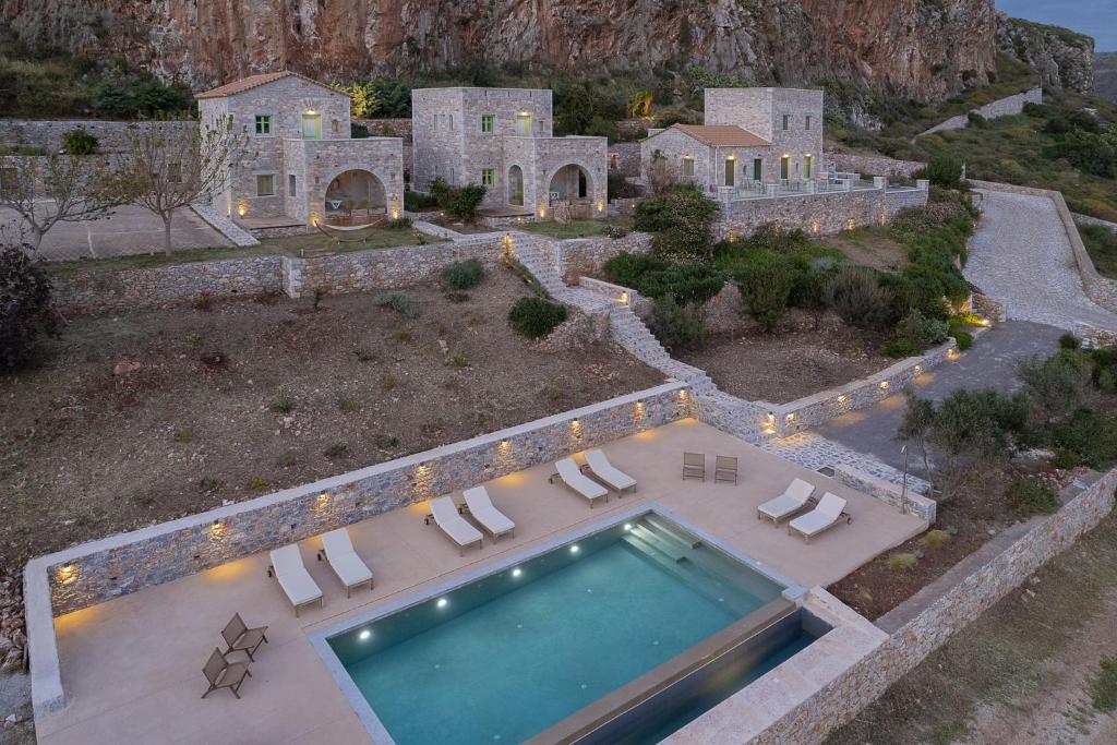 an aerial view of a house with a swimming pool at Alkyon SeaSide Studios in Neo Itilo