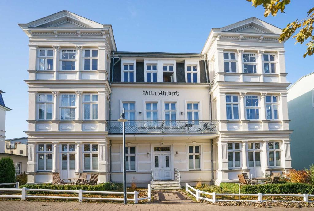 a large white building with a sign on it at Villa Ahlbeck Haus 1 in Ahlbeck