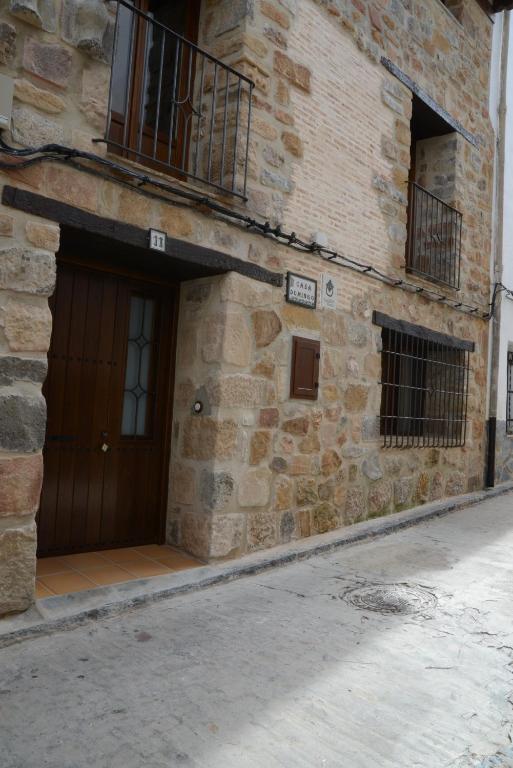 a brick building with a door and a balcony at Casa Domingo in Manzanera