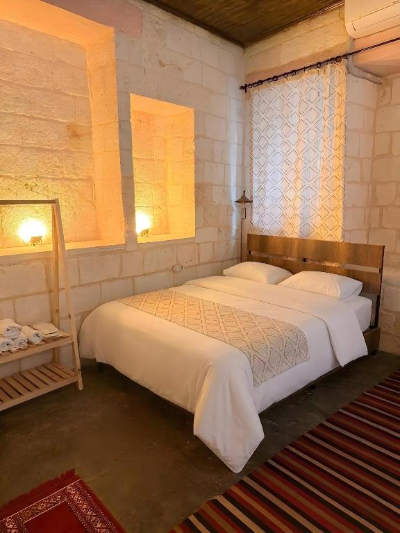 a bedroom with two beds and a window at Diib House Hotel in Urfa