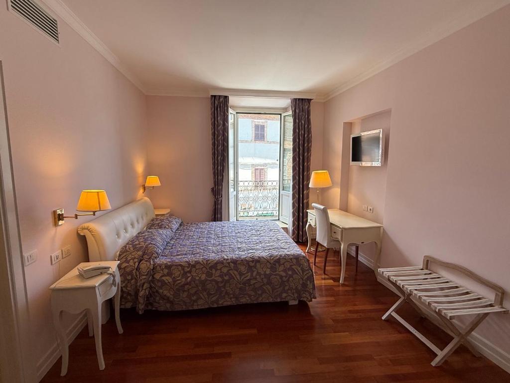 a hotel room with a bed and a window at Albergo Centrale in San Ginesio