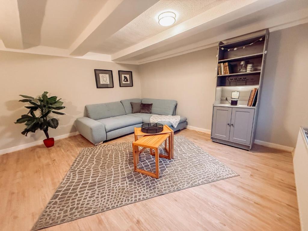 a living room with a couch and a table at Drei Linden Rosenwall in Wolfenbüttel
