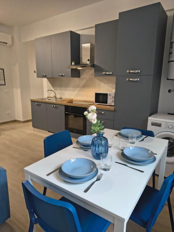 a white table with blue plates on it in a kitchen at NonSoloCitta' in Torrette
