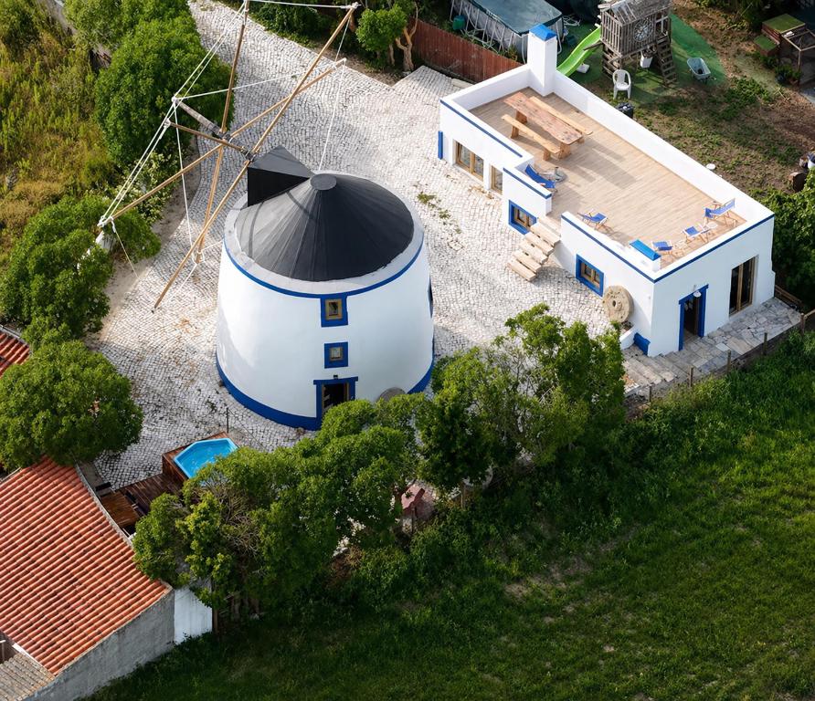 an aerial view of a small house with a silo at The Indigo Windmill Retreat, Peniche in Atouguia da Baleia