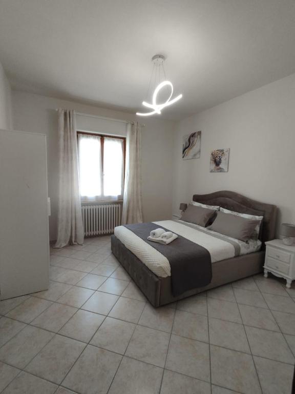 a bedroom with a large bed and a window at Casa Spartaco in Certaldo
