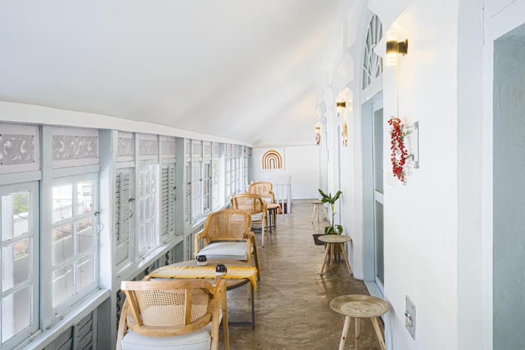 a corridor with chairs and tables in a room at FeelHome in Cochin