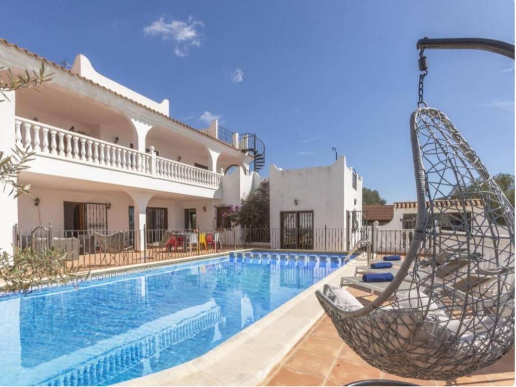a resort with a swimming pool with a swing at Finca Azahar in Sant Jordi