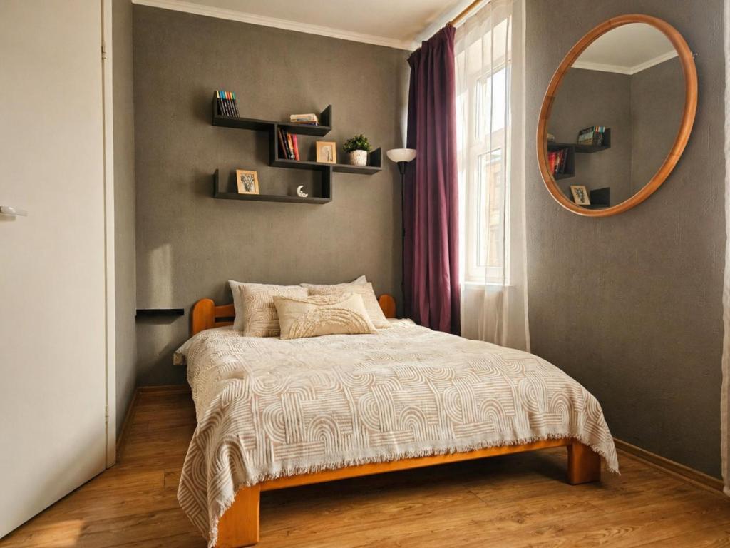 a bedroom with a bed and a round mirror at Muzeja apartamenti & Free Parking & Self Check-in in Riga