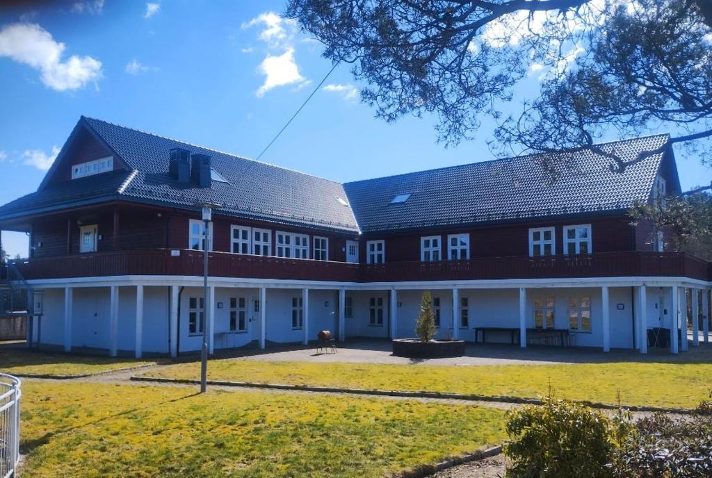 a large red and white building with a yard at Fanaseter in Bergen