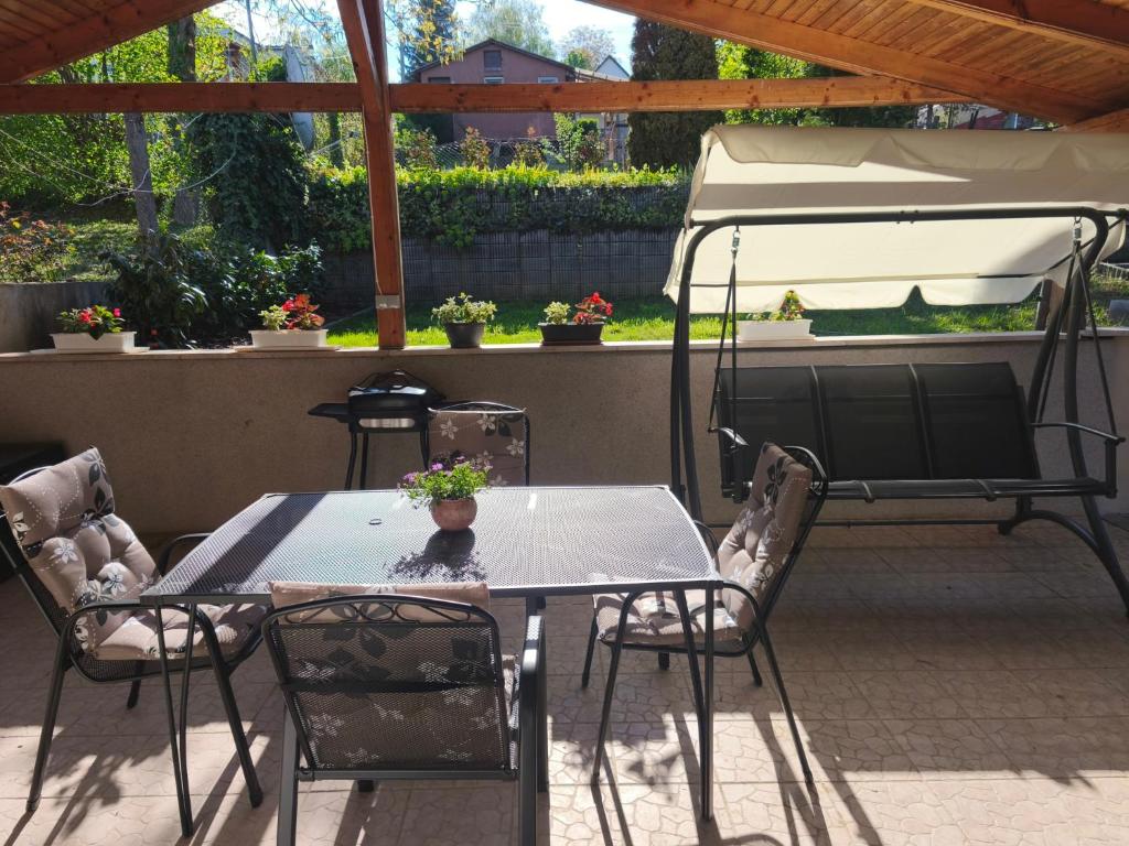 a table and chairs with a tent on a patio at Igali Kuckó in Igal