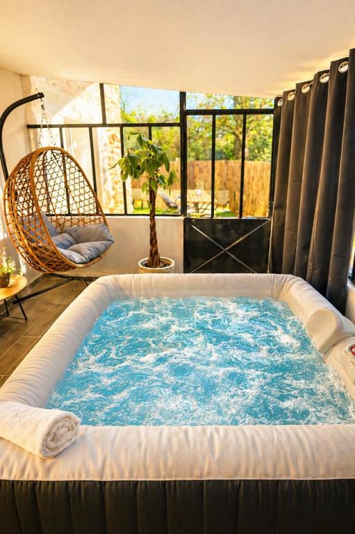 a jacuzzi tub in a room with a window at Maison avec Jacuzzi Privatif Calme Soleil Cote d Azur in La Crau
