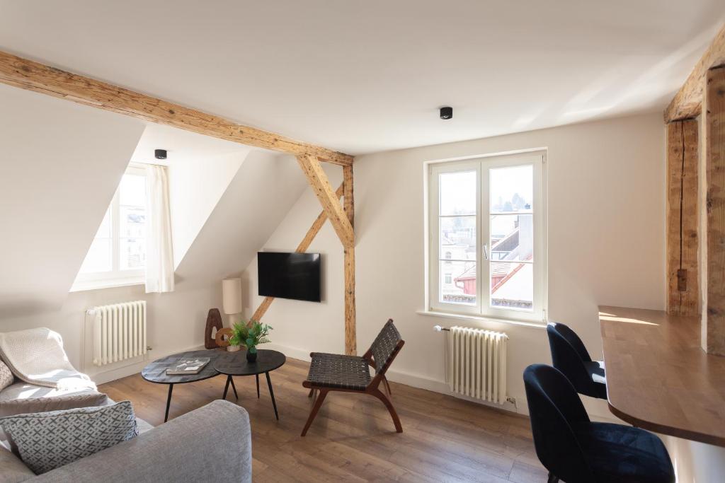 a living room with a couch and chairs at Boutique Charme Apartments Küferstr 10-12 in Baden-Baden