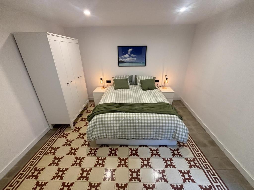 a bedroom with a large bed with two night stands at Apartamentos_Lovely_Rooms_Vic in Vic