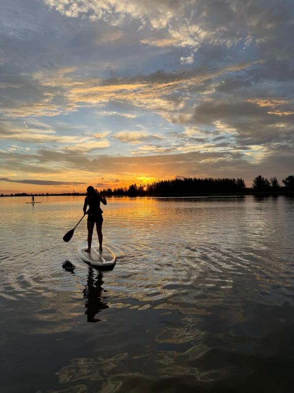a person on a paddle board in the water at Pousada Mar Vintage in Laguna