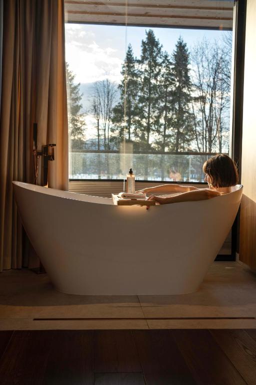a large bath tub in a bathroom with a window at Villa T Apartments & SPA in Zakopane