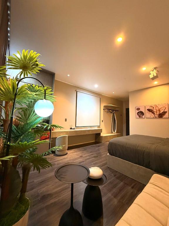 a room with a bed and a projection screen at YourHome - Stay & More in Hoàng Mai