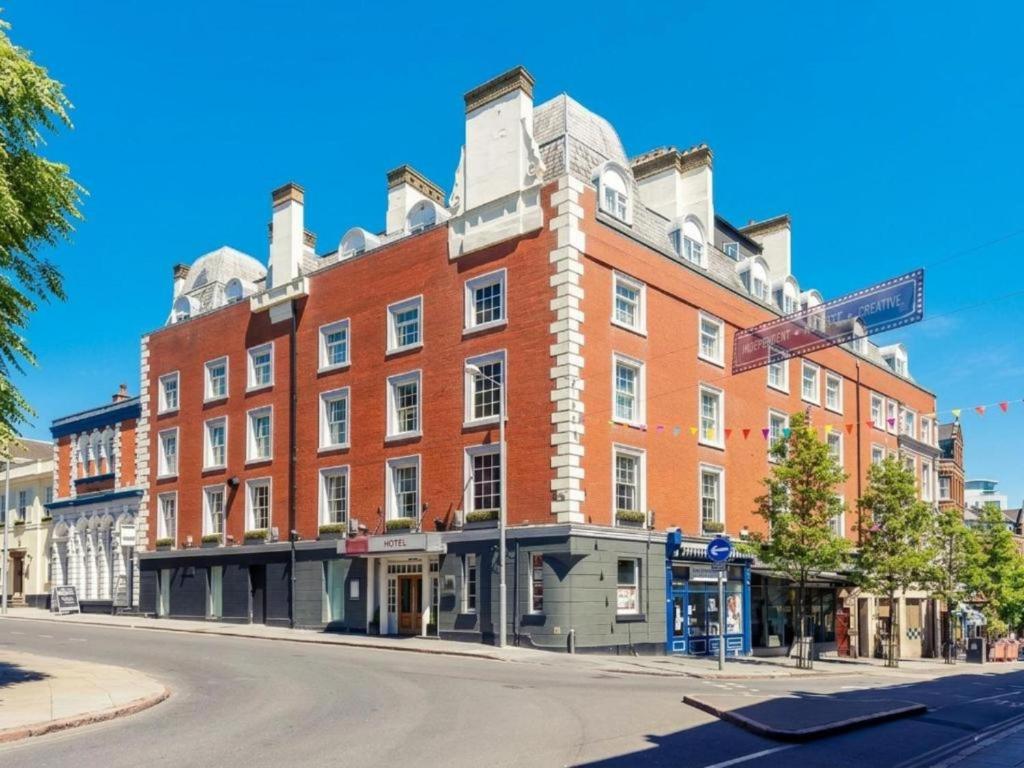 a large red brick building on the corner of a street at Nottingham City Centre Hotel by Sunday in Nottingham