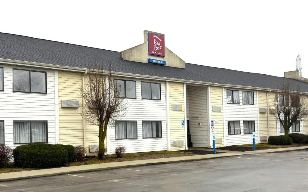a white building with a sign on top of it at Red Roof Inn Kokomo in Kokomo