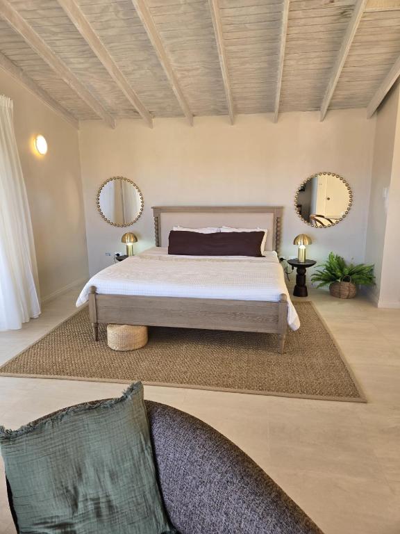 a bedroom with a bed and mirrors on the wall at Mullins Townhouse in Saint Peter