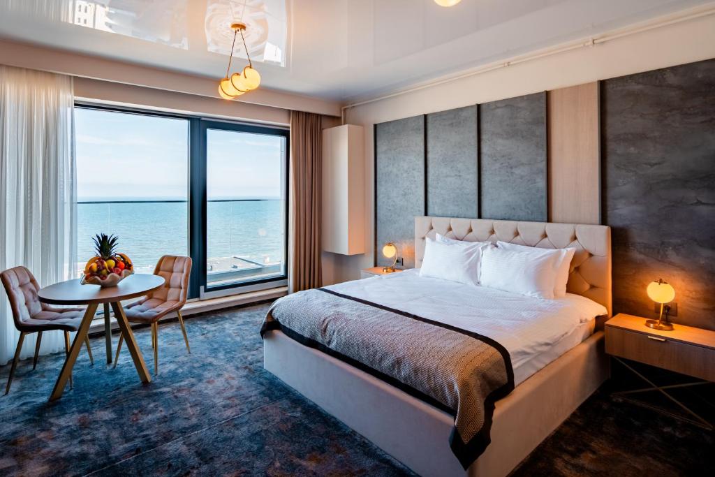 a hotel room with a bed and a table with a view at NOYA - Hotel Building Stefan Resort II in Mamaia Sat/Năvodari